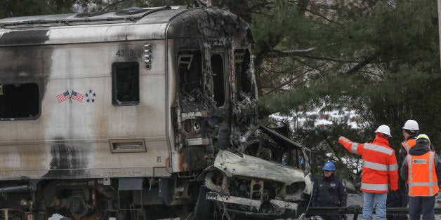 VALHALLA, NY - FEBRUARY 04: Officials inspect a Metro-North train crash with a sport utility vehicle that occurred last night on February 4, 2015 in Valhalla, New York. The crash started a fire in the train cars that killed seven people and a dozen injured. (Photo by Cem Ozdel/Anadolu Agency/Getty Images)