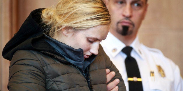 Abigail Hanna stands during her arraignment Monday, Nov. 23, 2015, at Newburyport District Court in Newburyport, Mass. A court psychologist said Hanna, charged with kidnapping a 2-year-old girl found naked and with her head shaved, is hallucinating. A judge held Hanna without bail and sent her for a 21-day competency evaluation. (Dina Rudick/The Boston Globe via AP, Pool)