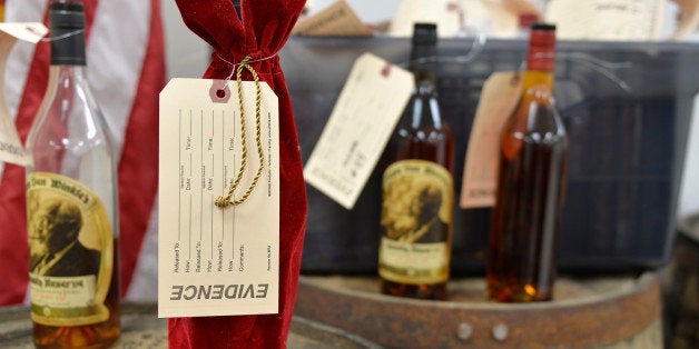 Evidence tags mark recovered bottles of Pappy Van Winkle bourbon shown during a news conference at the Franklin County Sheriff's Office, Tuesday, April 21, 2015, in Frankfort, Ky. Nine people were indicted relating to the theft of more than $100,000 worth of bourbon from the Wild Turkey and Buffalo Trace distilleries. (AP Photo/Timothy D. Easley)