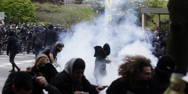 Police and protesters clash during a May Day march Friday, May 1, 2015, in downtown Seattle. (AP Photo/Ted S. Warren)