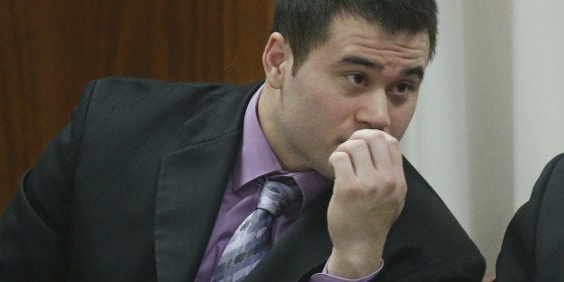 Daniel Holtzclaw talks to his attorneys as prosecutors continue their case in the second week of his trial in Oklahoma City, Thursday, Nov. 12, 2015. Holtzclaw, a former Oklahoma City police officer, is facing dozens of charges alleging he sexually assaulted 13 women while on duty. (AP Photo/Sue Ogrocki)