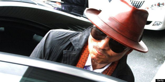 Kenichi Shinoda, the boss of Japan's largest 'yakuza' gang, the Yamaguchi-gumi, gets into a car after arriving at the train station in Kobe, western Japan on April 9, 2011 after he was released from a Tokyo prison after serving time since 2005. AFP PHOTO / JIJI PRESS (Photo credit should read JIJI PRESS/AFP/Getty Images)