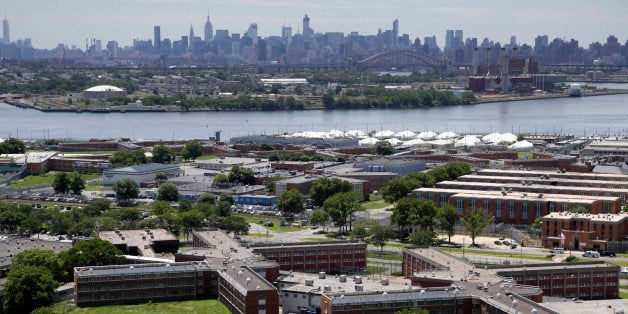 FILE- This June 20, 2014 file photo shows the Rikers Island jail with the New York skyline in the background. Over the past five years, there have been three deaths in New York City's jails in which inmates were alleged to have been fatally beaten by guards. Yet in none of those cases was anyone ever charged with a crime. (AP Photo/Seth Wenig, File)