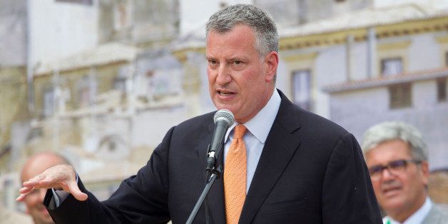 GRASSANO, ITALY - JULY 24: New York City mayor Bill de Blasio speaks during a ceremony to receive honorary citizenship during a visit to his grandmother's town on July 24, 2014 in Grassano, Italy. The New York City mayor and his family are on an eight-day holiday in Italy but de Blasio has plans to meet with Italys foreign minister, Federica Mogherini, and with Cardinal Pietro Parolin, Vatican secretary of state. (Photo by Giovanni Marino/Getty Images)