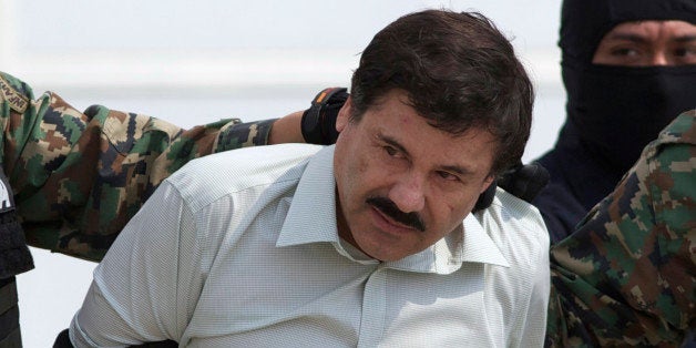 FILE - This Feb. 22, 2014 file photo shows Joaquin "El Chapo" Guzman, the head of Mexicoᅢ까タᅡルs Sinaloa Cartel, being escorte