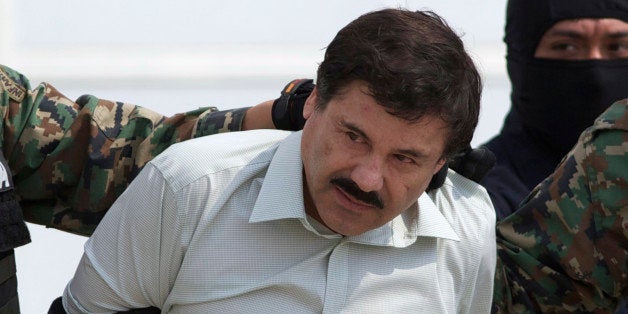 FILE - This Feb. 22, 2014 file photo shows Joaquin "El Chapo" Guzman, the head of Mexicoￃﾢￂﾀￂﾙs Sinaloa Cartel, being escorted to a helicopter in Mexico City following his capture overnight in the beach resort town of Mazatlan. On Monday, Nov. 24, 2014, at federal court in Chicago, a U.S. judge sentenced Alfredo Vasquez-Hernandez, a reputed lieutenant of Guzman, to 22 years in prison for his role in a $1 billion trafficking conspiracy, saying the stiff sentence should send a message to traffickers everywhere. The case is regarded as one of the U.S. government's most important against Mexican cartels. Guzman remains jailed in Mexico and Mexican authorities haven't said if they might extradite him to Chicago. (AP Photo/Eduardo Verdugo, File)