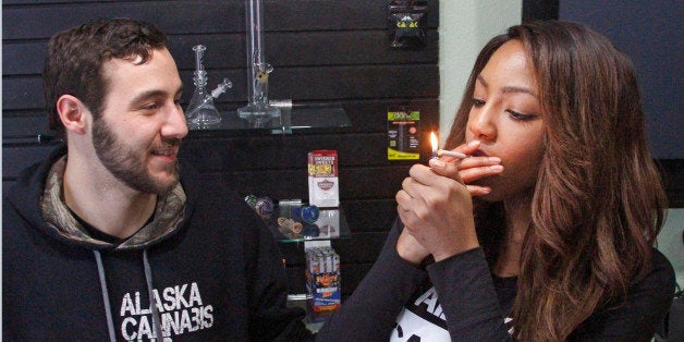 FILE - In this Feb. 20, 2015, file photo, Peter Lomonaco, co-founder of the Alaska Cannabis Club, and CEO Charlo Greene smoke