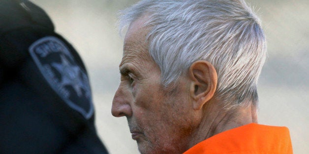 FILE - In this Tuesday, March 17, 2015, file photo, Robert Durst is escorted into Orleans Parish Prison after his arraignment in Orleans Parish Criminal District Court in New Orleans. The whispered words of Durst recorded in an unguarded moment in a bathroom could come back to haunt him - or help him - as he faces a murder charge. A possible move by prosecutors to introduce the incriminating material from a six-part documentary on his strange life and connection to three killings could back fire as interview footage did in the Michael Jackson molestation trial and the Robert Blake murder case. (AP Photo/Gerald Herbert, File)