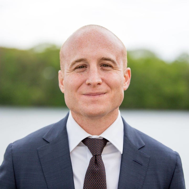 Democrat Max Rose speaks to a small business owner in Staten Island, New York.