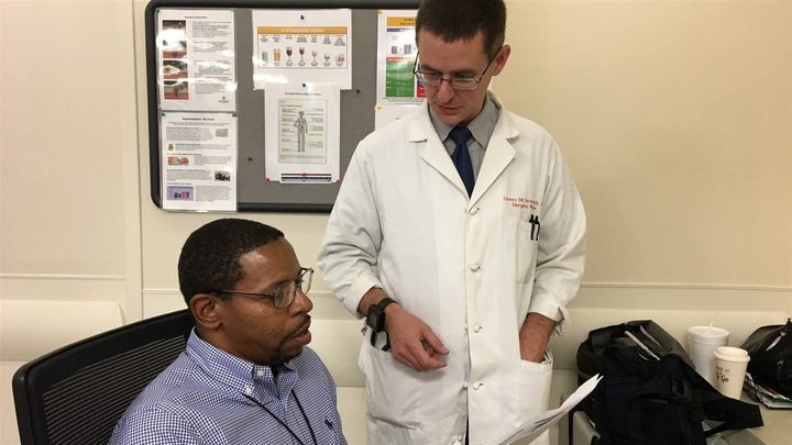 <p>Recovery coach Dwayne Dean, left, and Dr. Zachary Dezman confer about a patient at the University of Maryland Medical Center Midtown Campus in West Baltimore. </p>