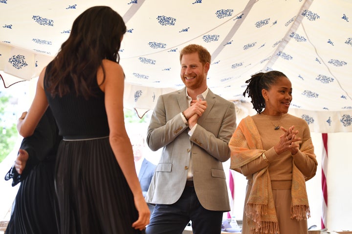 The Duke of Sussex looks at Meghan, Duchess of Sussex, during her first solo royal hosting event. Meghan's mother, Doria Ragland, flew in from Los Angeles for the special event.