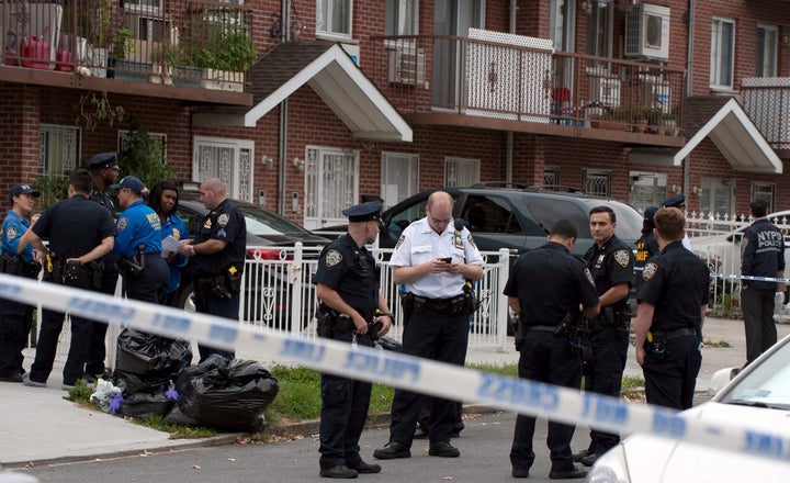 Police gather outside the daycare center, located in a private home in New York City.