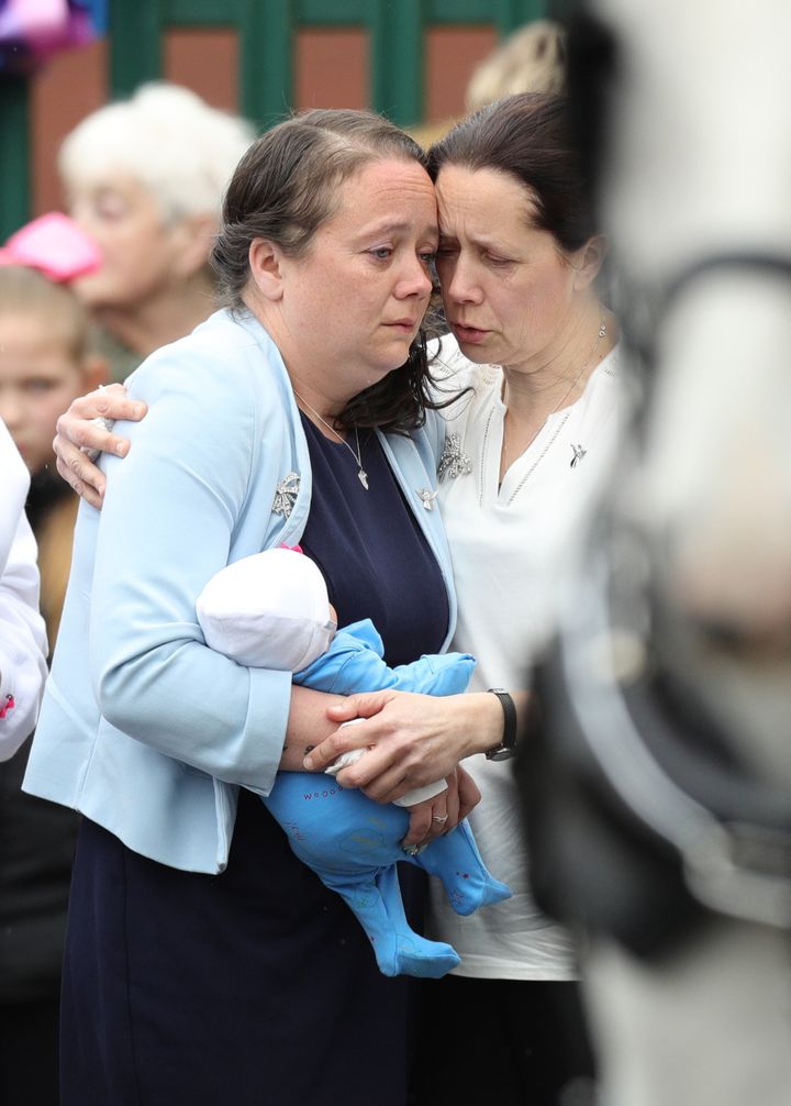 Mylee Billingham's mother Tracey Taundry holds a doll as she arrives at the funeral of the eight-year-old stabbing victim at St James' Church, Walsall.