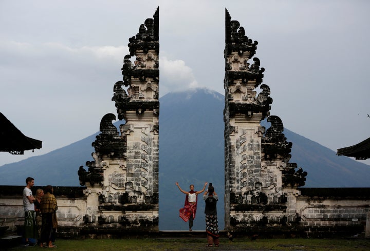 Tourists visit Lempuyang temple which overlooks the Mount Agung volcano, in Karangasem, Bali, Indonesia, Dec. 3, 2017.