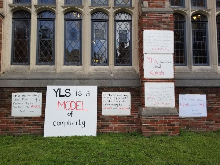 Student signs accuse Yale Law School's administrators of "complicity" in sexual misconduct.