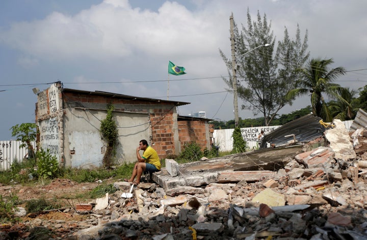 A man sits atop the rubble of his home in Vila Autodromo, a Rio de Janeiro neighborhood that was destroyed to make way for the city's 2016 Olympic park.