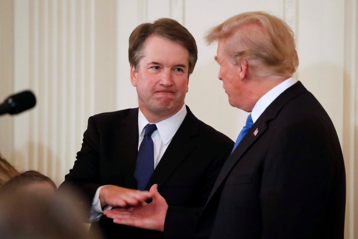 Supreme Court nominee Judge Brett Kavanaugh shakes hands with President Donald Trump.