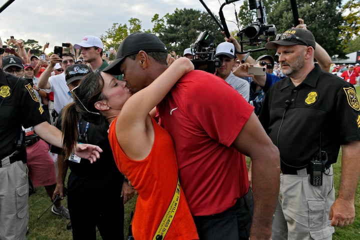 Tiger Woods and girlfriend Erica Herman kiss after the final round Sunday of the Tour Championship in Atlanta.