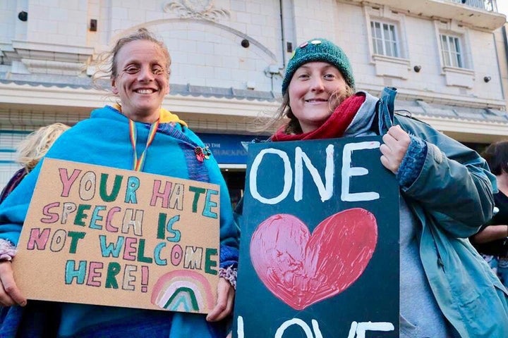 Protesters hold signs outside Franklin Graham's evangelical rally in Blackpool.