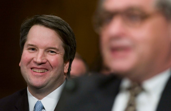 Brett Kavanaugh watches his former boss Alex Kozinski testify at a Senate confirmation hearing.