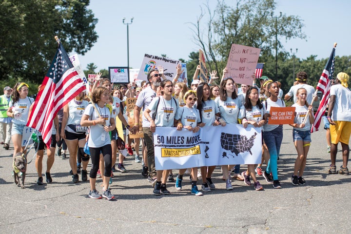 Student activists march the final mile of the 50 Miles More walk against gun violence on their way to a rally at the Smith & Wesson Firearms factory on Aug. 26 in Springfield, Massachusetts.