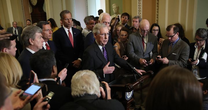 Senate Majority Leader Mitch McConnell (R-Ky.), center, tells the press Tuesday at the Capitol that he is confident Republicans "are going to win" the confirmation of Brett Kavanaugh to the Supreme Court.