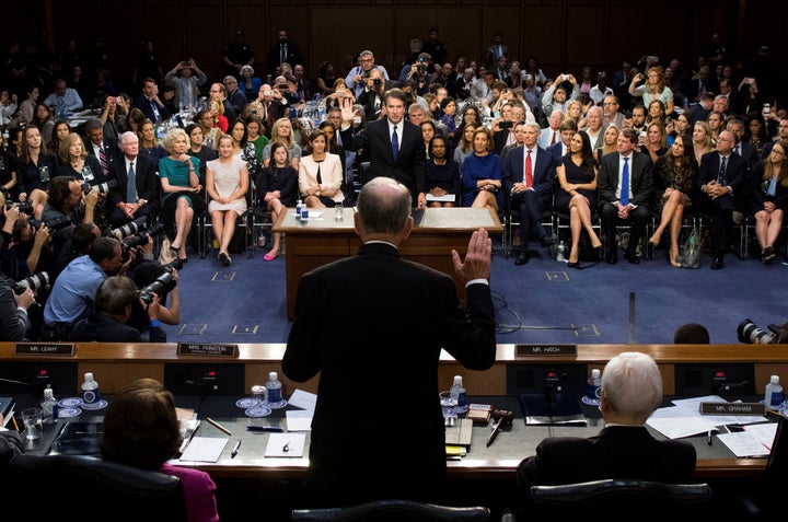 Supreme Court nominee Brett Kavanaugh is sworn in by Sen. Chuck Grassley (R-Iowa) before a Senate Judiciary Committee hearing on his confirmation.