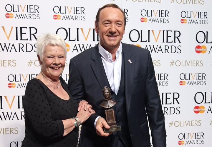 Dame Judi Dench and Kevin Spacey, winner of the Special Award, pose in the winners room at The Olivier Awards on April 12, 20
