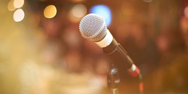 microphone in concert hall or conference room with warm lights in background