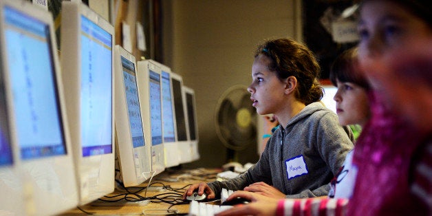 BOULDER, CO - DECEMBER 8: Maya Chastang, center, looks at her screen while working on a program during a coding event at Univ