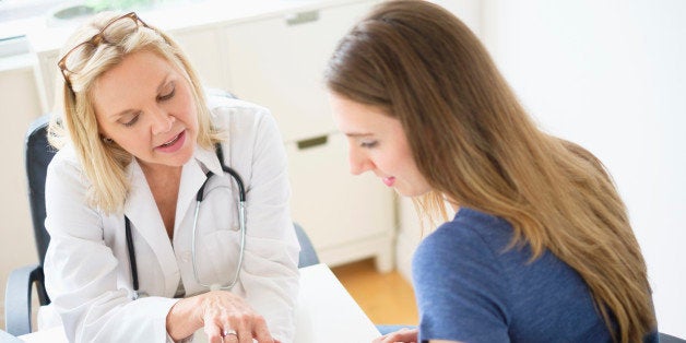 USA, New Jersey, Doctor talking to patient in office