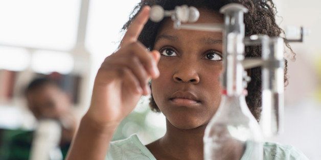 Black student doing experiment in science lab