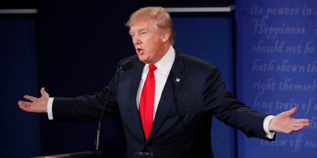 Republican U.S. presidential nominee Donald Trumpspeaks as Democratic U.S. presidential nominee Hillary Clinton listens durin