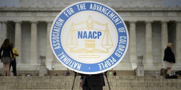 A sign with the logo of the National Association for the Advancement of Colored People(NAACP), is seen during a rally at the