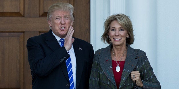 BEDMINSTER TOWNSHIP, NJ - NOVEMBER 19: (L to R) president-elect Donald Trump and Betsy DeVos pose for a photo after their meeting at Trump International Golf Club, November 19, 2016 in Bedminster Township, New Jersey. Trump and his transition team are in the process of filling cabinet and other high level positions for the new administration. (Photo by Drew Angerer/Getty Images)