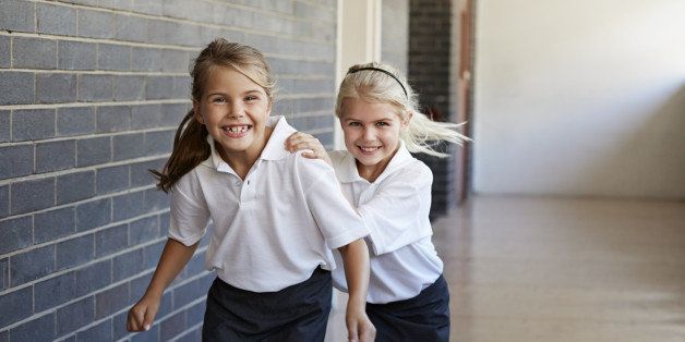 Schoolgirls running & having fun in a corridor