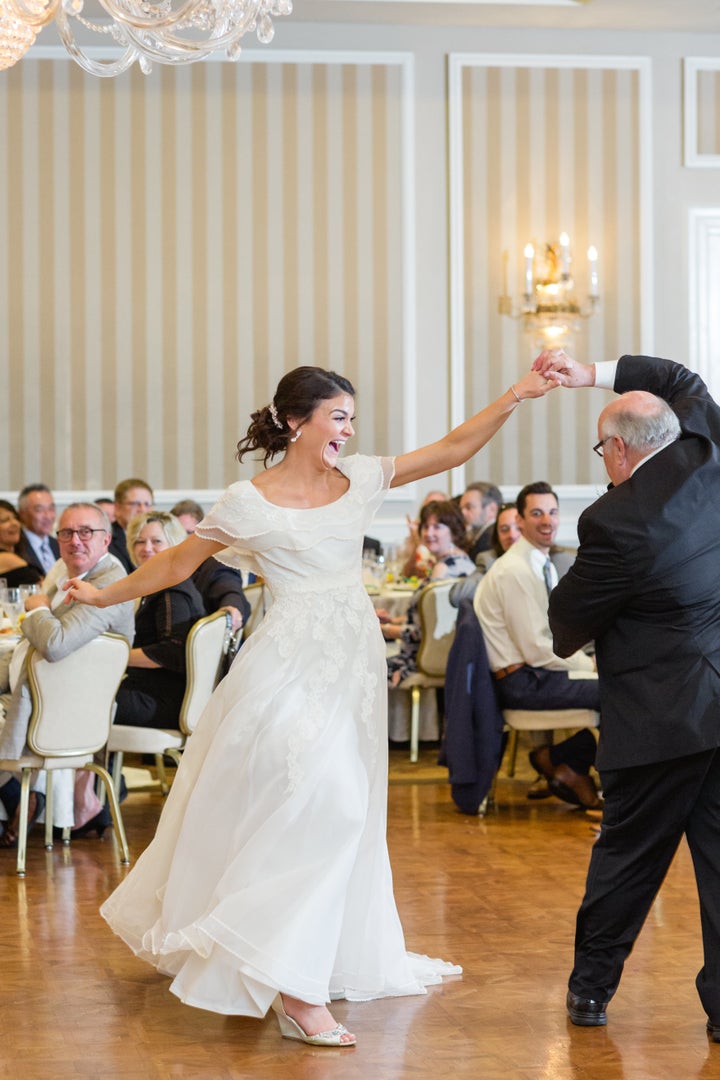 The bride twirls in her mom's wedding dress during the father-daughter dance.