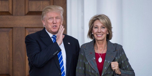BEDMINSTER TOWNSHIP, NJ - NOVEMBER 19: President-elect Donald Trump stands with Betsy DeVos after a meeting at Trump National