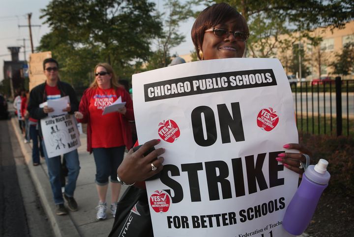 CHICAGO, IL - SEPTEMBER 17: Striking Chicago public school teachers picket outside of George Westinghouse College Prep high school on September 17, 2012 in Chicago, Illinois. More than 26,000 teachers and support staff walked off of their jobs on September 10 after the Chicago Teachers Union failed to reach an agreement with the city on compensation, benefits and job security. With about 350,000 students, the Chicago school district is the third largest in the United States. (Photo by Scott Olson/Getty Images)