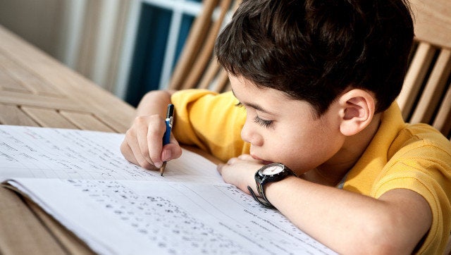 Young boy doing his homework at home.