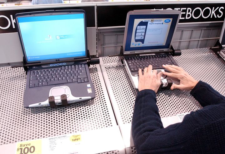 402026 07: A man tests a Compaq laptop that sits next to a Hewlett Packard laptop on display at a Best Buy store March 7, 2002 in San Francisco, CA. Standard & Poors cut Hewlett-Packard Co.s long-term debt ratings three notches because because of falling profits and risks associated with its proposed merger with lower-rated rival Compaq Computer Corp. (Photo by Justin Sullivan/Getty Images)