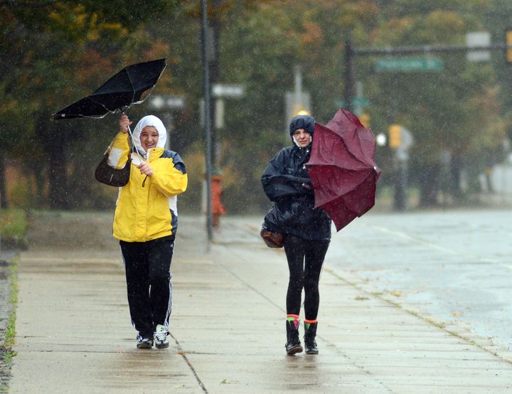 PHILADELPHIA, PA - OCTOBER 29: Two women try to hold on to their umbrellas in a wind soaked rainfall as Hurricane Sandy approaches October 29, 2012 in Philadelphia, Pennsylvania. Philadelphia Mayor Michael Nutter ordered that all city offices be closed Monday and Tuesday due to potential damage from Hurricane Sandy. Public transit will remain shut down as well.(Photo by William Thomas Cain/Getty Images)