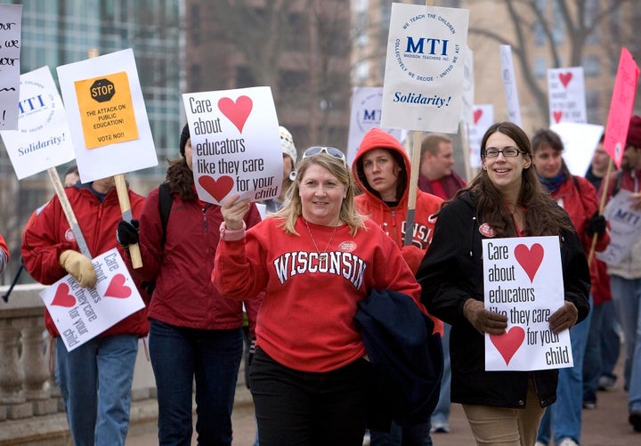 MADISON, WI - FEBRUARY 16: Teacher Cyndi Ehrhart (L) and Anne McClure (R) join protesters marching at the State Capitol building on February 16, 2010 in Madison, Wisconsin. Protesters were demenstrating against Wisconsin Gov. Scott Walker's proposal to eliminate collective bargaining rights for many state workers. (Photo by Mark Hirsch/Getty Images)