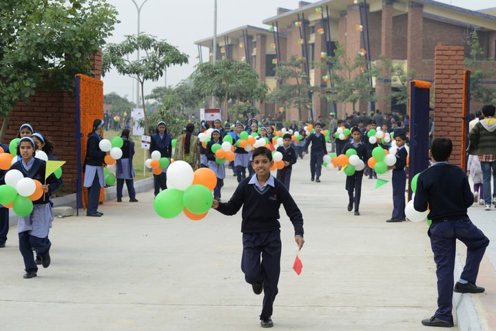 Schoolchildren hold balloons while on campus at the Vidyagyan Leadership Academy in Bulandshahr on December 16,2012. The stat