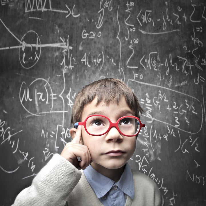 Thinking child with a blackboard in the background