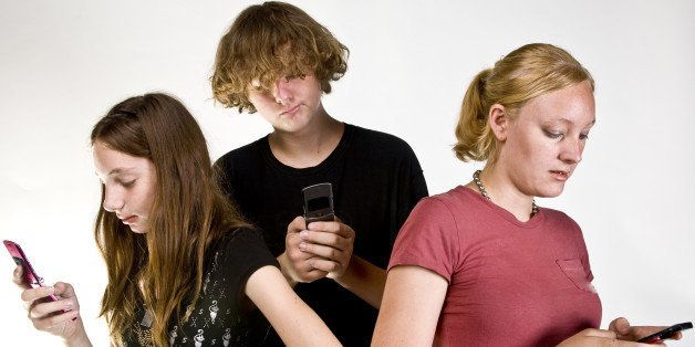 teen aged siblings texting on...
