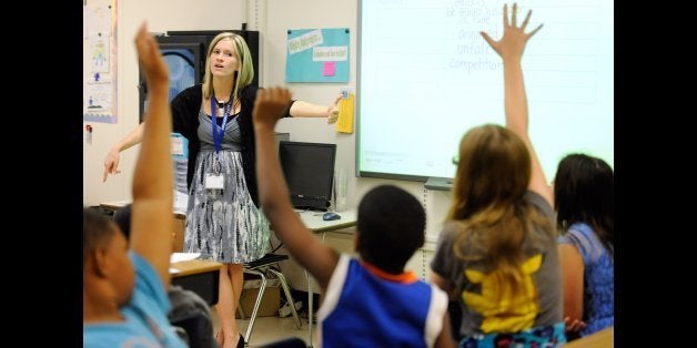 In this Oct. 1, 2013, file photo, Amy Lawson, a fifth-grade teacher at Silver Lake Elementary School in Middletown, Del., teaches an English language arts lesson. The school has begun implementing the national Common Core State Standards for academics. The Common Core standards will quickly become more tangible for four million U.S. school kids beginning March 18, 2014, who will help field test the two main assessments created based on the standards.(AP Photo/Steve Ruark, File)