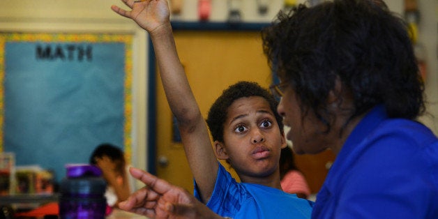 TAKOMA PARK, MD - MAY 16: Stephane Mbenga goes over fractions with long term substitute teacher Naomi Wamble in a fourth grade math class at Piney Branch Elementary School in Takoma Park, MD on May 16, 2013. Montgomery County Fourth and Fifth grade math teachers are training themselves to teach students in a new style of learning math to prepare them for newer, more rigorous education standards under Common Core. (Photo by Linda Davidson / The Washington Post via Getty Images)