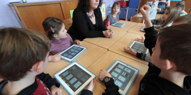 TO GO WITH AFP STORY BY CEDRIC SIMON
Nursery school pupils prepare to work with tablet computers on March 18, 2013 in Haguen