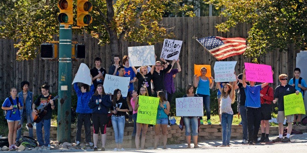 LITTLETON, CO - SEPTEMBER 24: Student walk-outs in Jefferson County continued for the third straight day after students from Chatfield High School and Dakota Ridge High School left classes in protest of school board decisions and proposals, September 24, 2014. Students for the two schools joined together, at the corner of Ken Caryl and Chatfield Blvd. in Littleton, to wave sings. (Photo by RJ Sangosti/The Denver Post via Getty Images)